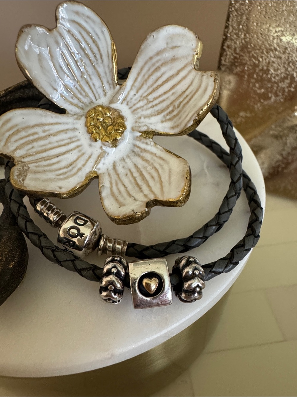 Pandora Grey leather braided bracelet with three heart charms.